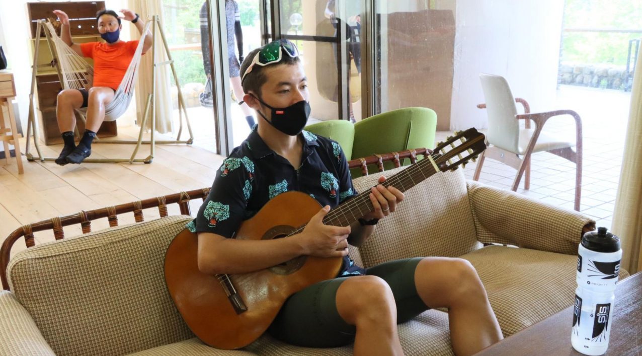 LivingAnywhere Commons会津磐梯でギターをひきながら休憩する男性